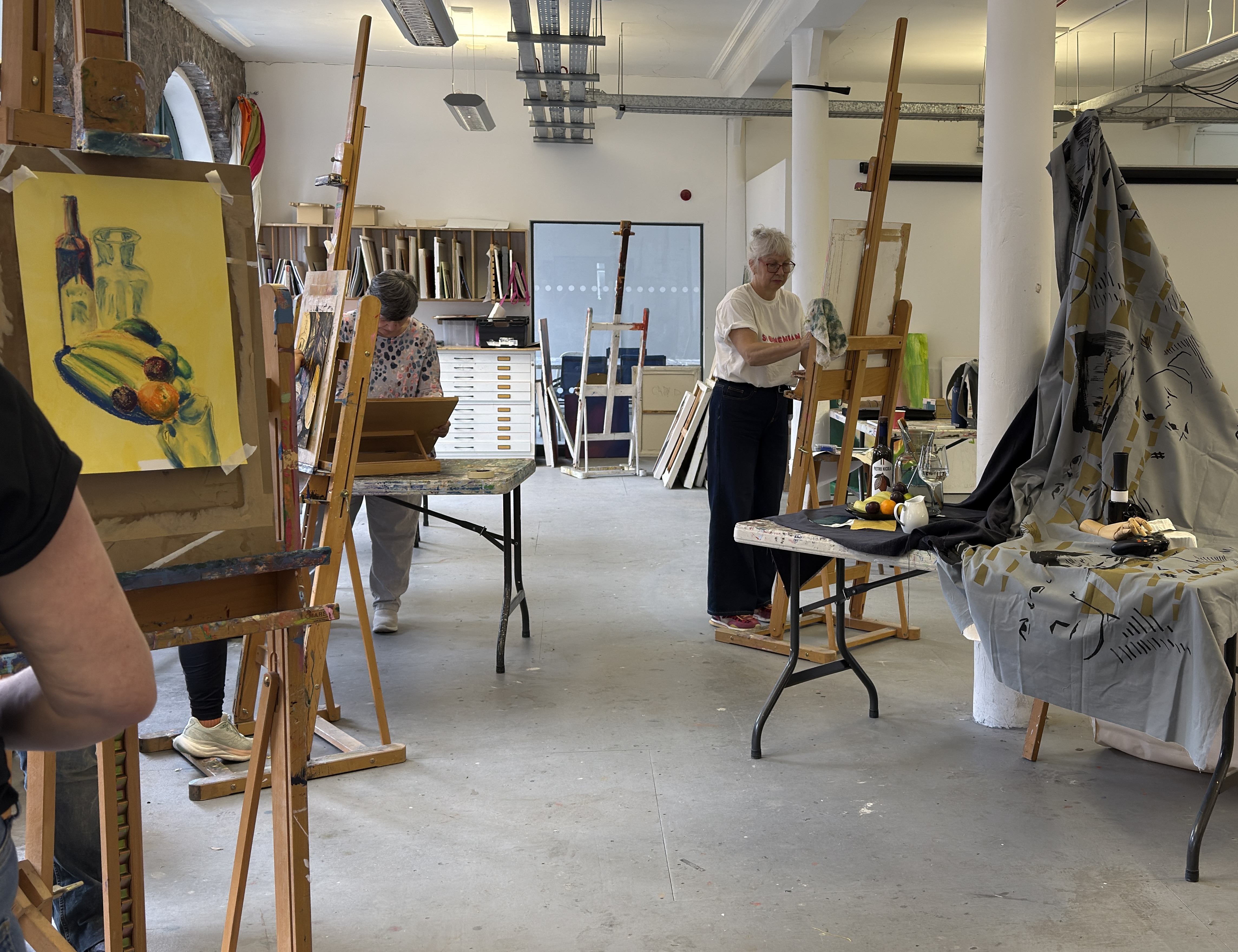 Workshop participants working with drawings and materials during a studio-based session.